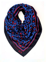 90% Modal, 10% Cashmere. Handrolled hem. Lightweight and soft feel.  This beautiful, New Zealand designed scarf is in our custom designed animal print and a striking colour combination of red and cobalt blue.  Bold and colourful, ready to brighten up any day and add a touch of style.   Dimensions are 120x120cm  Our scarves are delicate and should be handled with care. They are handmade and each one is slightly unique.  Delivered in an elegant reusable gift bag.